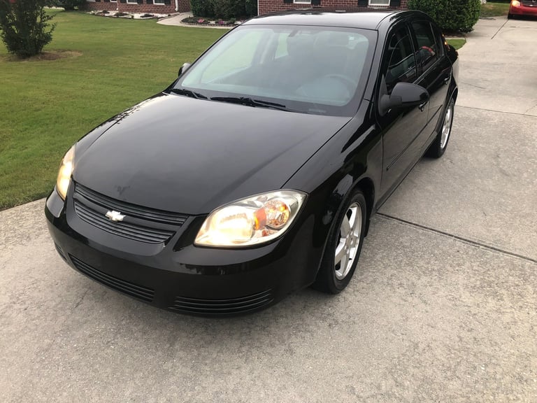 Shiny black Chevrolet Cobalt after detailing