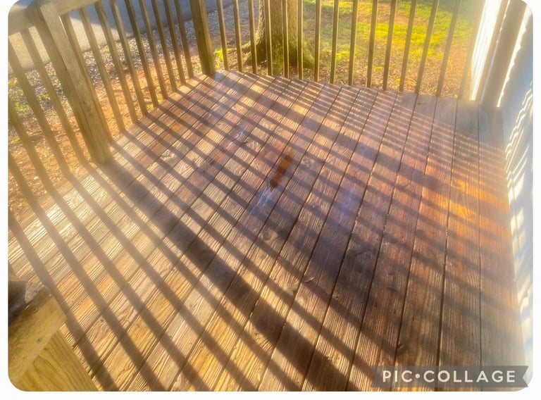 Sunlight casting striped shadows from a railing onto a wooden deck floor during golden hour