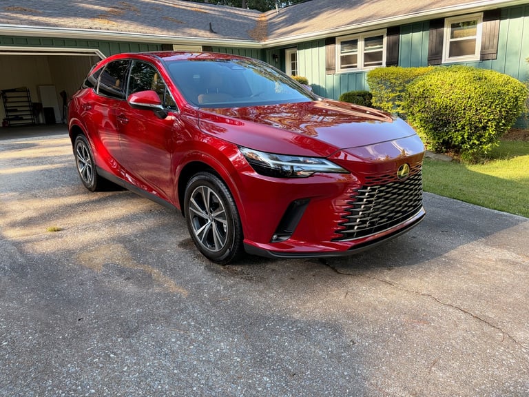 Red Lexus SUV parked in driveway of residential home