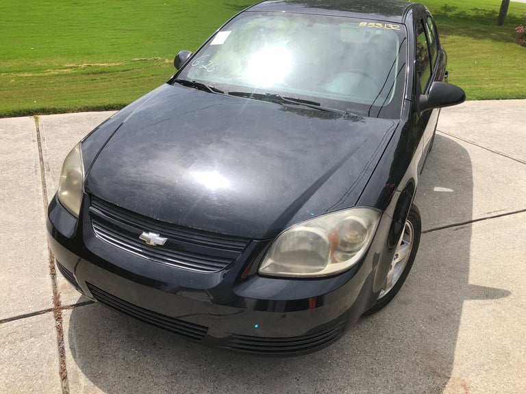 Black Chevrolet sedan on driveway